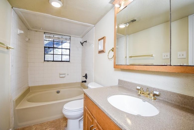 full bathroom featuring vanity, tile patterned floors, tiled shower / bath combo, and toilet