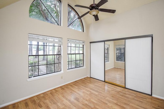 unfurnished bedroom with light hardwood / wood-style floors and multiple windows