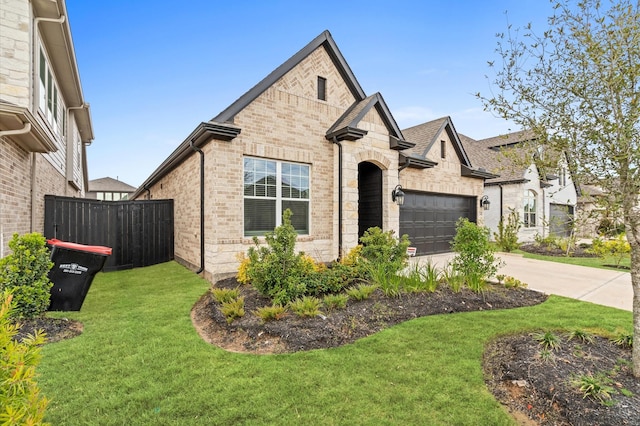 view of front of home featuring a garage and a front lawn