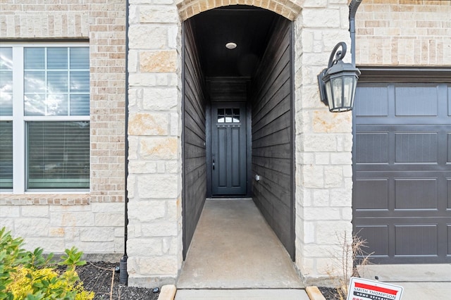 doorway to property featuring a garage