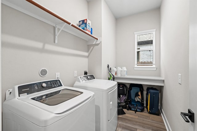 washroom featuring light hardwood / wood-style floors and washing machine and clothes dryer