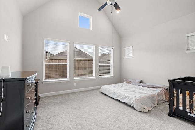 carpeted bedroom featuring ceiling fan and high vaulted ceiling