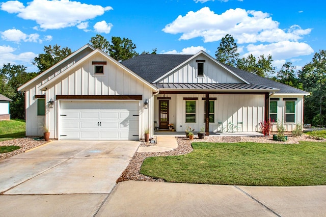 modern farmhouse with a front yard, a porch, and a garage