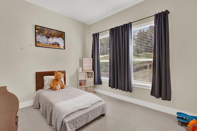 carpeted bedroom featuring multiple windows