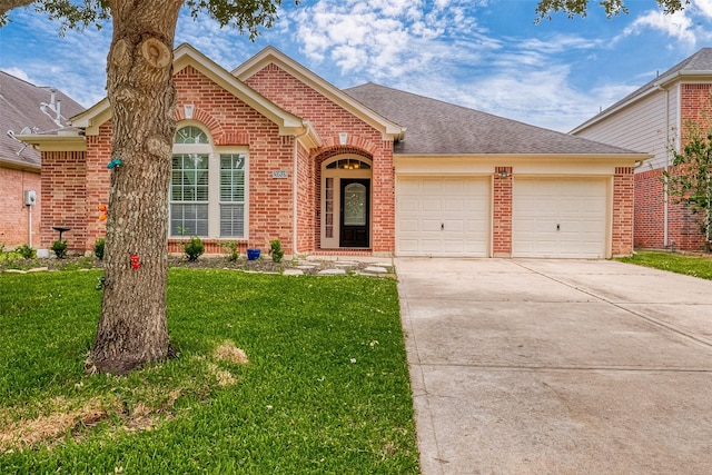 front of property with a garage and a front lawn