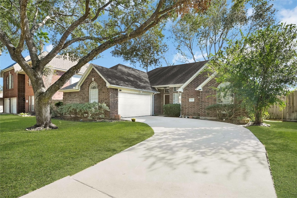 view of front of house with a garage and a front yard