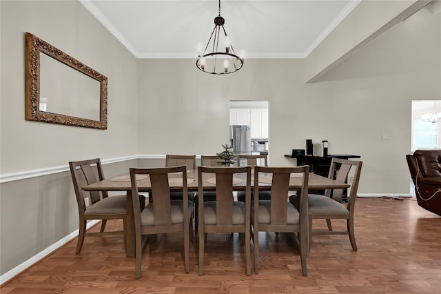 dining area with a chandelier, hardwood / wood-style flooring, and ornamental molding