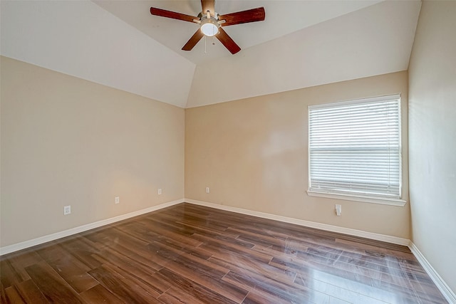 empty room featuring ceiling fan, dark wood-type flooring, and vaulted ceiling