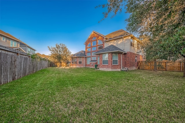 rear view of house featuring a lawn