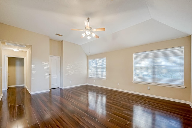 empty room featuring ceiling fan, dark wood-type flooring, and vaulted ceiling