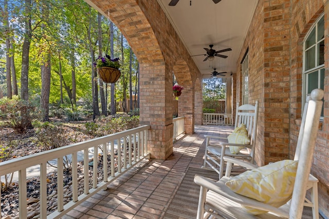 wooden terrace with ceiling fan and a porch