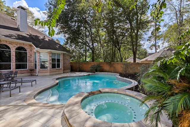 view of pool with an in ground hot tub and a patio