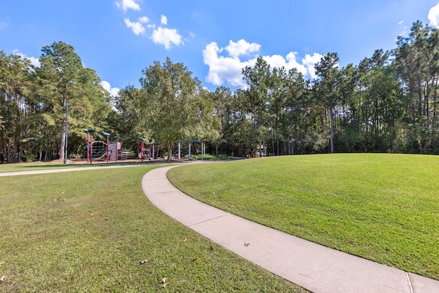 view of community with a lawn and a playground