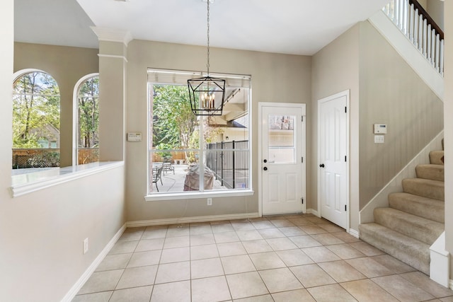 interior space with a chandelier and light tile patterned floors