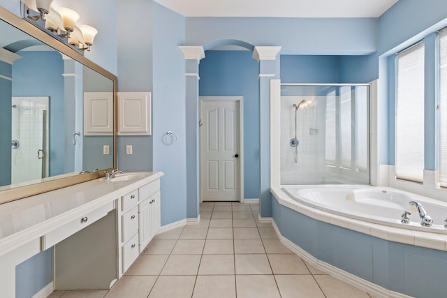 bathroom with tile patterned floors, decorative columns, vanity, and shower with separate bathtub