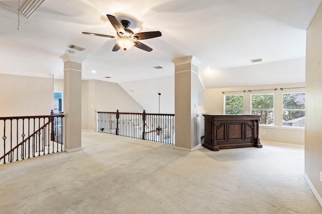 corridor featuring light colored carpet, lofted ceiling, and crown molding