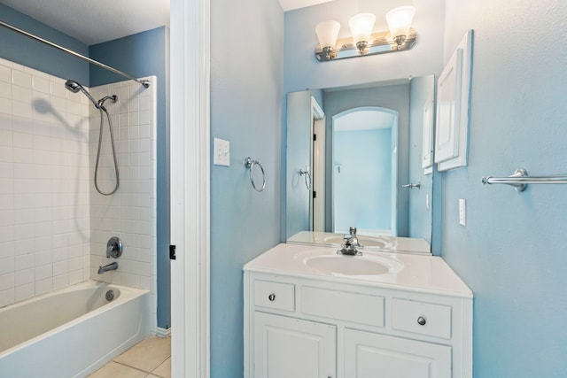 bathroom with vanity, tiled shower / bath combo, and tile patterned floors