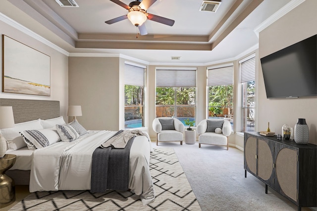 carpeted bedroom with multiple windows, a raised ceiling, ceiling fan, and crown molding