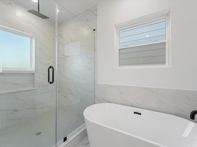 bathroom with tile walls and plus walk in shower