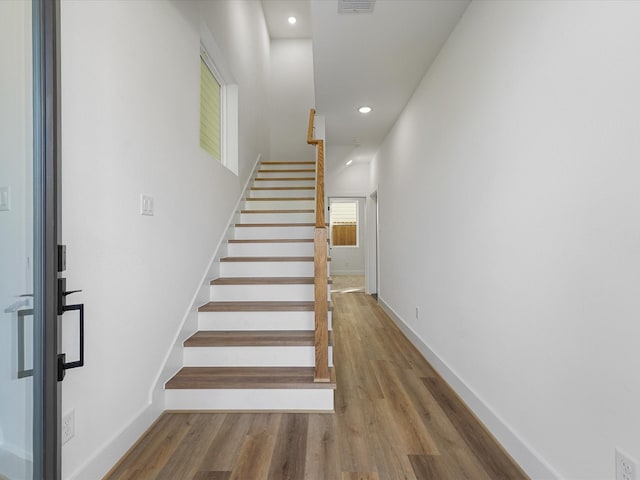 stairs featuring hardwood / wood-style flooring