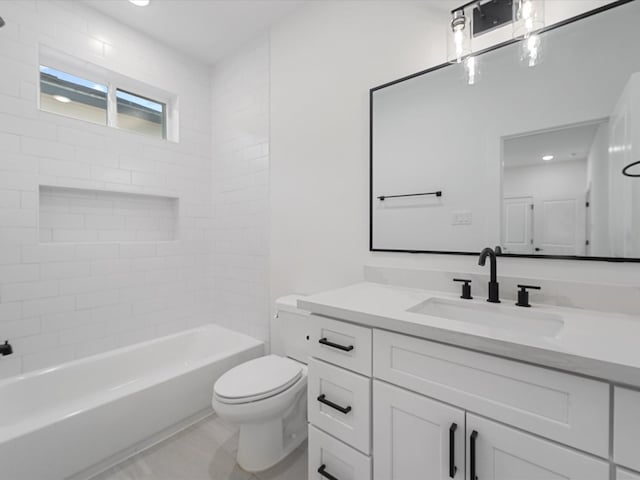 full bathroom featuring vanity, tiled shower / bath combo, and toilet