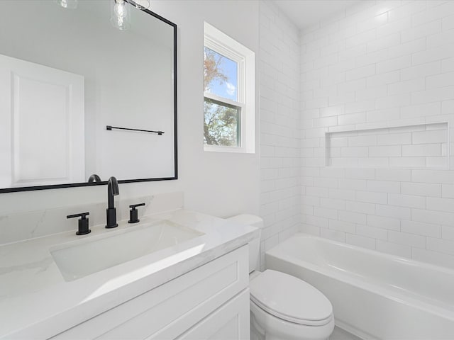 full bathroom featuring vanity, toilet, and tiled shower / bath combo