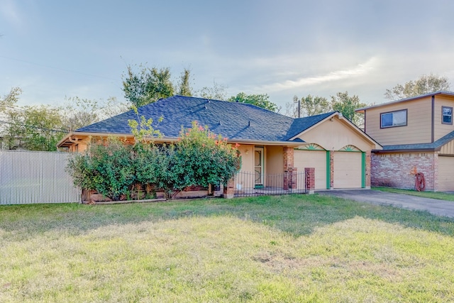 ranch-style house featuring a front yard and a garage