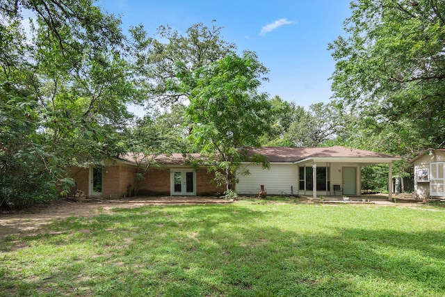 back of house with a lawn, french doors, and a patio