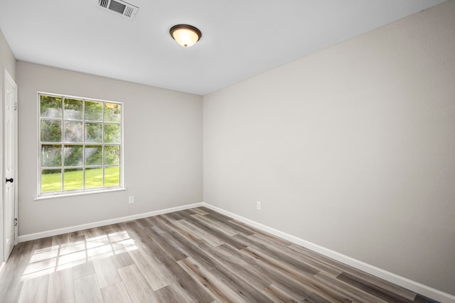 unfurnished room featuring hardwood / wood-style flooring