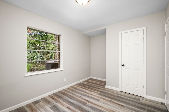 unfurnished bedroom featuring hardwood / wood-style floors and a closet