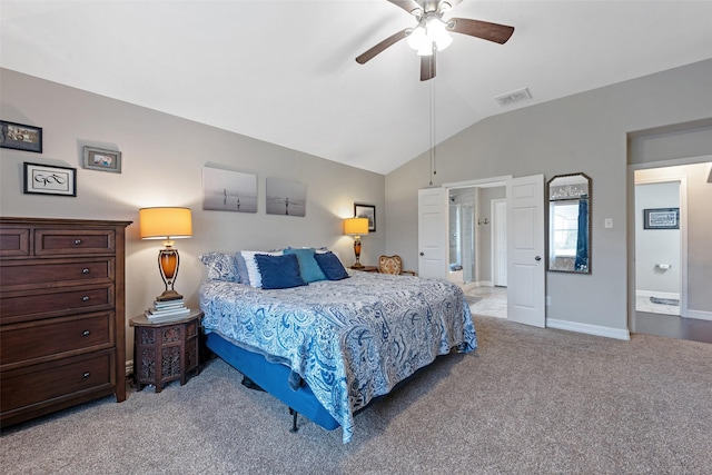 carpeted bedroom featuring ceiling fan, lofted ceiling, and ensuite bath