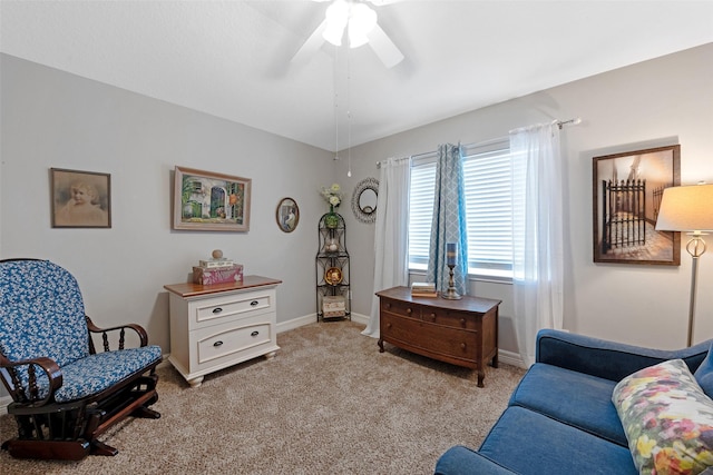 sitting room with ceiling fan and light carpet