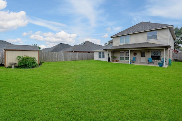 rear view of house with a yard and a patio