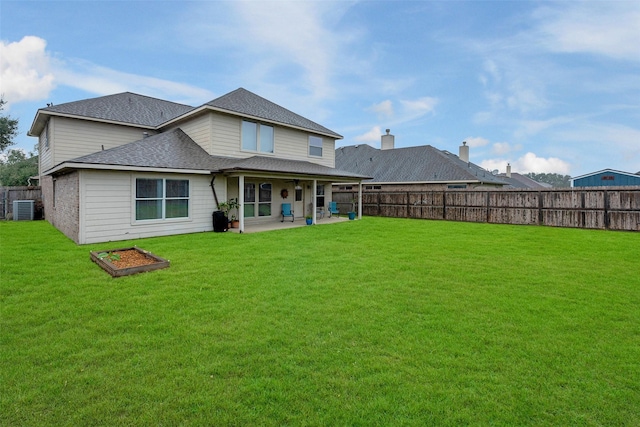 back of house with a patio, central air condition unit, and a lawn