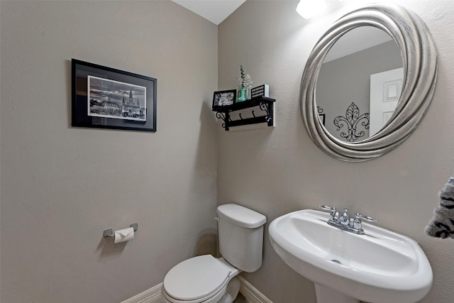 bathroom featuring toilet and sink