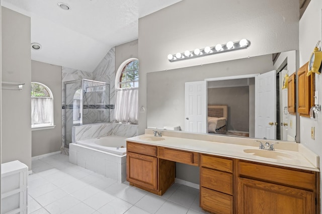 bathroom featuring vanity, tile patterned flooring, plus walk in shower, and vaulted ceiling