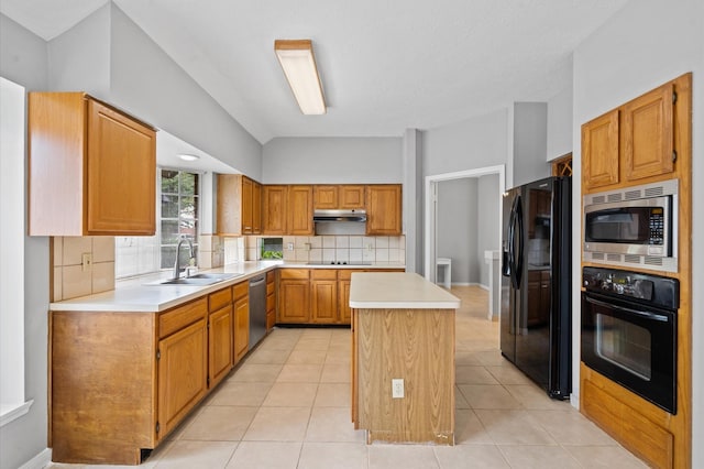 kitchen with sink, a center island, black appliances, and light tile patterned floors