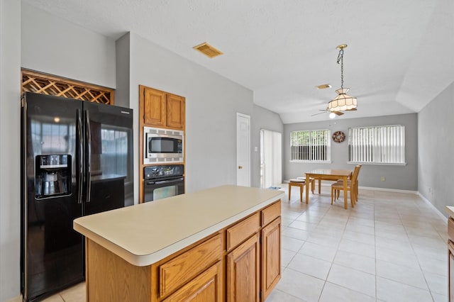 kitchen with ceiling fan, black appliances, light tile patterned floors, decorative light fixtures, and a center island