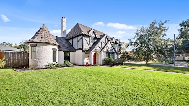 tudor house featuring a front yard