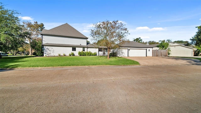 view of front facade with a garage and a front yard