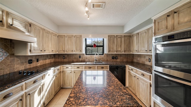 kitchen featuring decorative backsplash, light tile patterned floors, sink, and black appliances