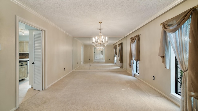 corridor featuring crown molding, light colored carpet, a textured ceiling, and an inviting chandelier