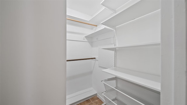 walk in closet with tile patterned floors