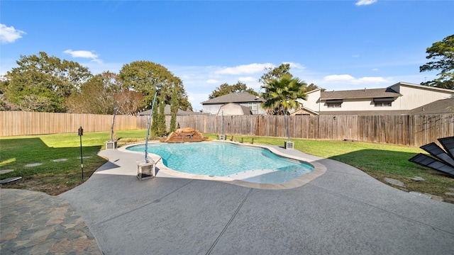 view of swimming pool with a patio area and a yard