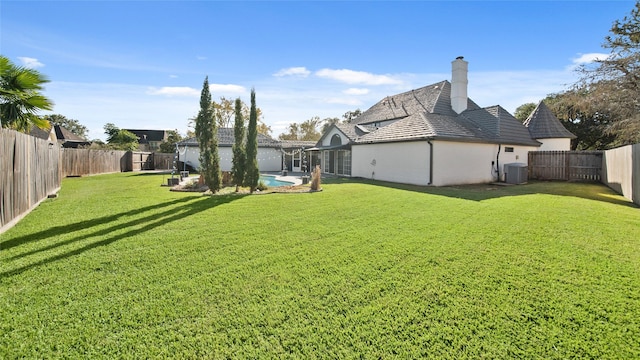 view of yard featuring a fenced in pool and cooling unit