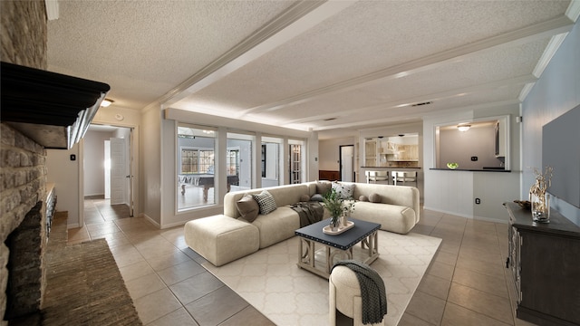 living room with a stone fireplace, ornamental molding, a textured ceiling, and light tile patterned floors