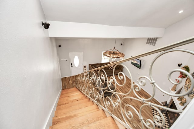 staircase featuring wood-type flooring