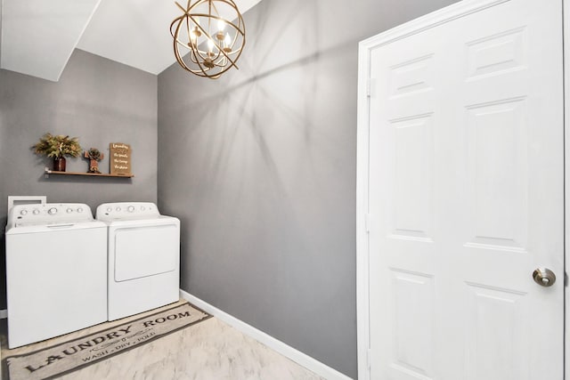 laundry area featuring washer and clothes dryer and a chandelier