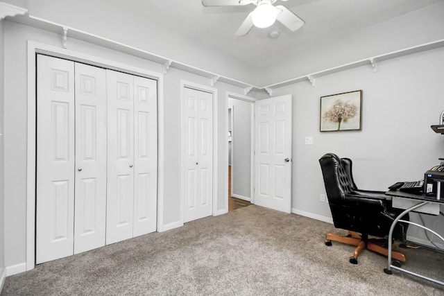 carpeted home office featuring ceiling fan