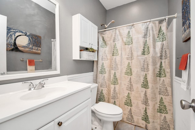 bathroom with tile patterned floors, vanity, toilet, and walk in shower